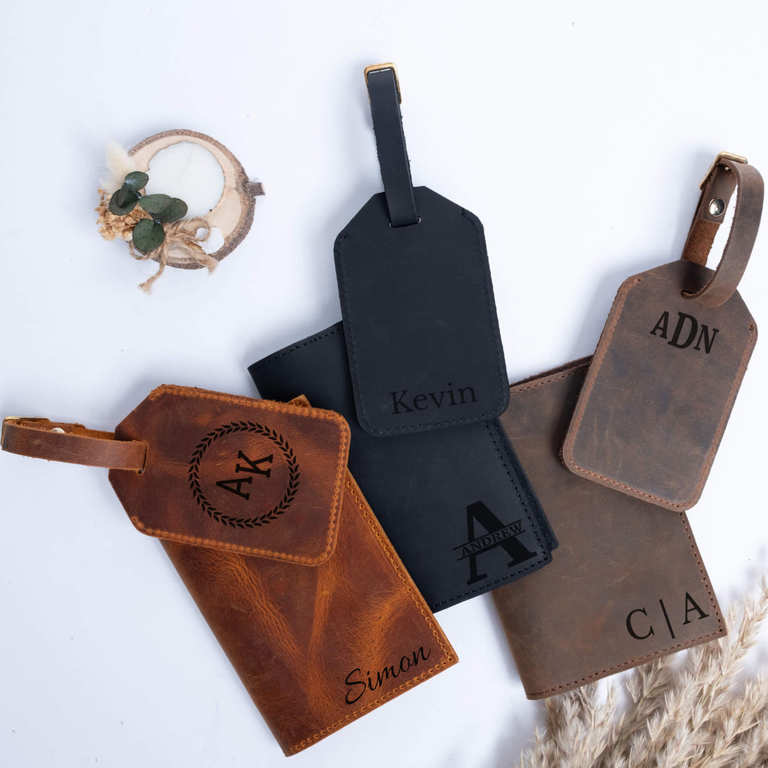 Engraved leather passport covers and luggage tags laid out for a trip