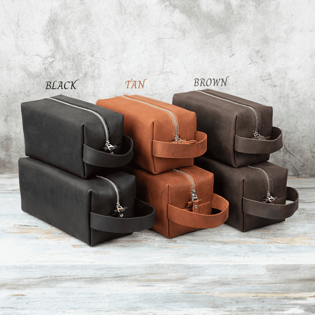 Leather toiletry bags in black, tan, and brown